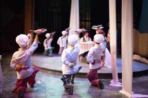 Servers present dishes to Prince Eric and Ariel