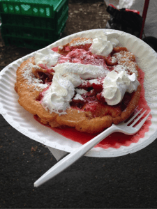 A funnel cake covered in an astounding variety of flavored sugars.