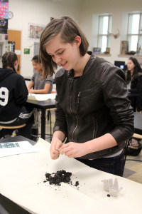 Sophomore Caitlin Peckham prepares her seed bomb. Photo by Allison Bullard