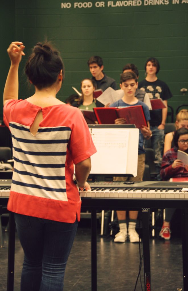 The cast of MMC rehearsing music. 